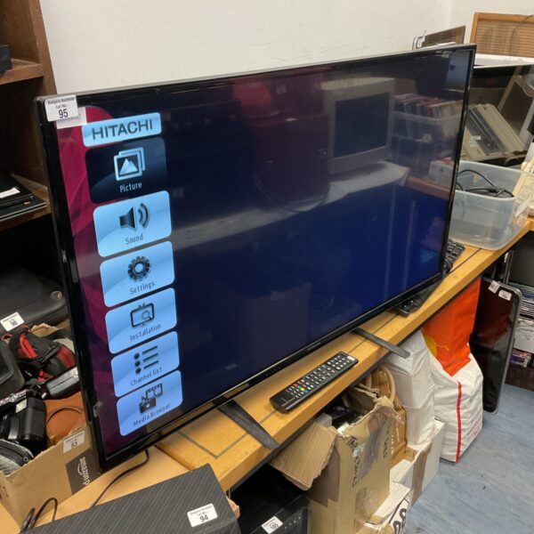 Hitachi 43 inch HD television with remote control for home entertainment.