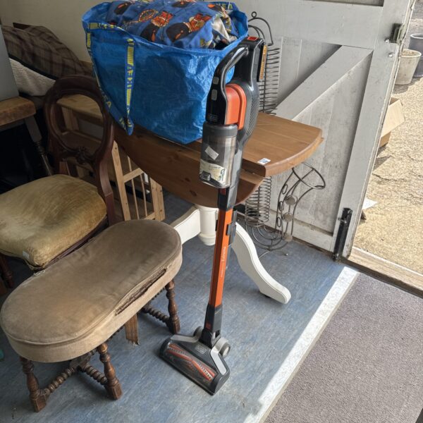 Black & Decker cordless hoover in used condition, ideal for quick cleaning.