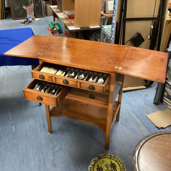 Antique Edwardian walnut cutlery chest with silver cutlery displayed.
