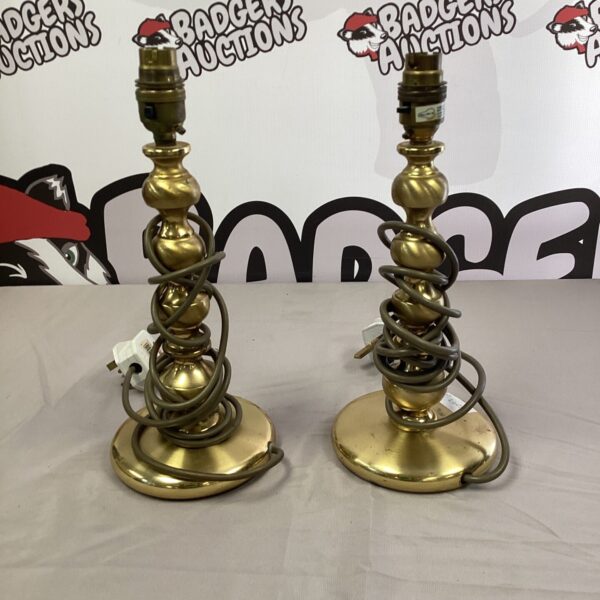 Two vintage brass table lamps with spiraling stems.
