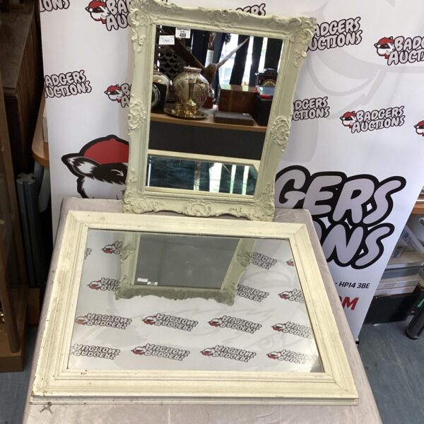 Pair of vintage wall mirrors with ornate wooden frames.