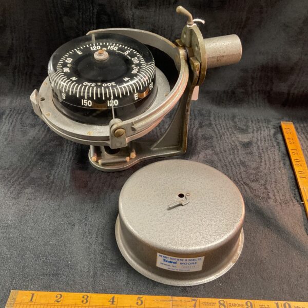 Antique Sestrel Moore compass with visible dial and gimballed mount.