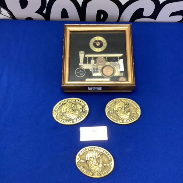 Vintage brass steam rally badges and steam engine plaque collection.