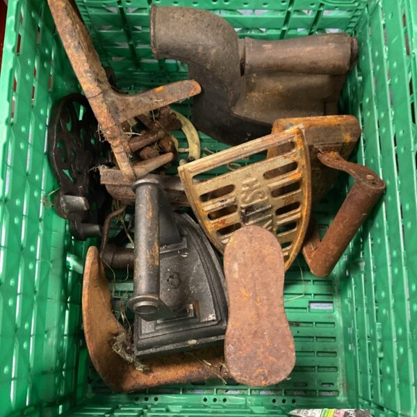 Antique iron collection with vintage irons and a shoe last.