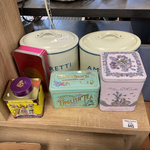 Selection of vintage tea tins with floral patterns.