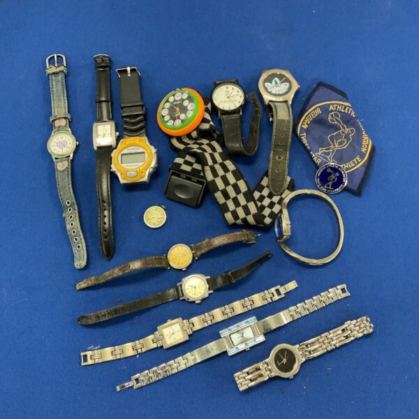 Group of vintage wristwatches including Guinness and Timex brands.