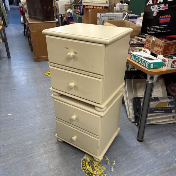 Pair of white painted pine bedside cabinets with two drawers.