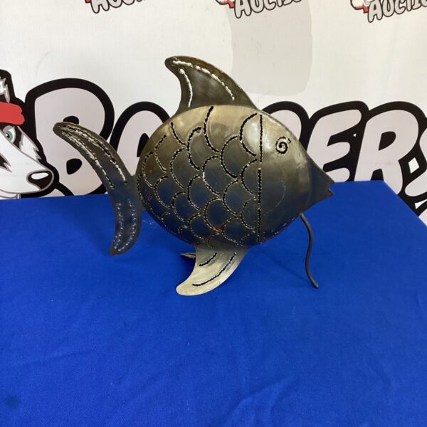 Decorative metal fish tealight holder for warm ambiance.