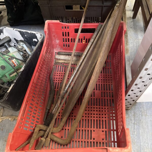 A lot of vintage metal hand tools, showing signs of age.