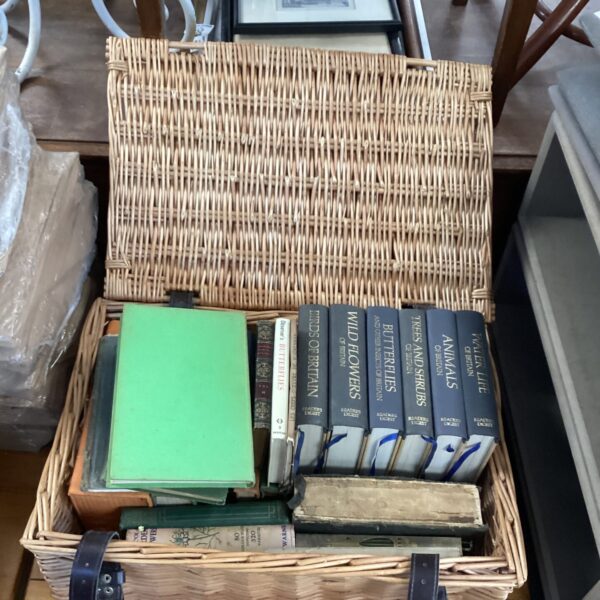 Vintage Reader's Digest books arranged in a woven wicker basket.