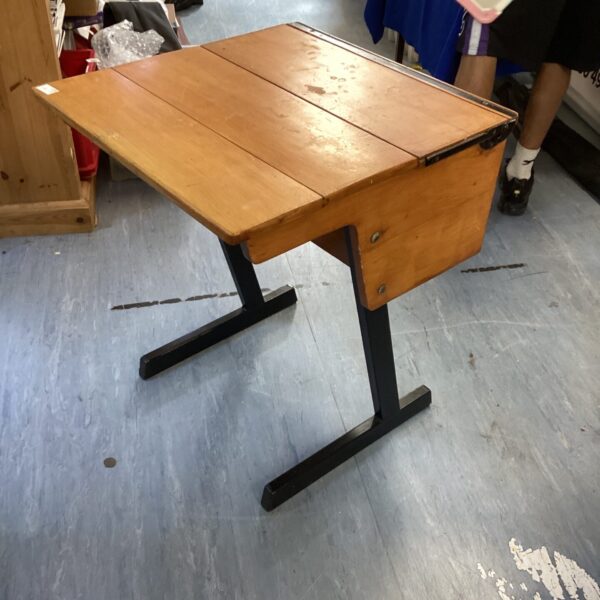 Vintage wooden school desk with cast iron frame.
