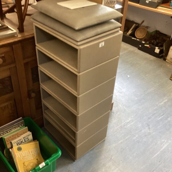 Grey modern storage unit with four tiers.