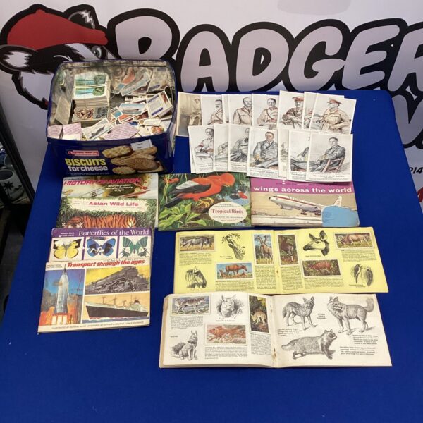 Vintage cigarette card albums and military postcards collection.