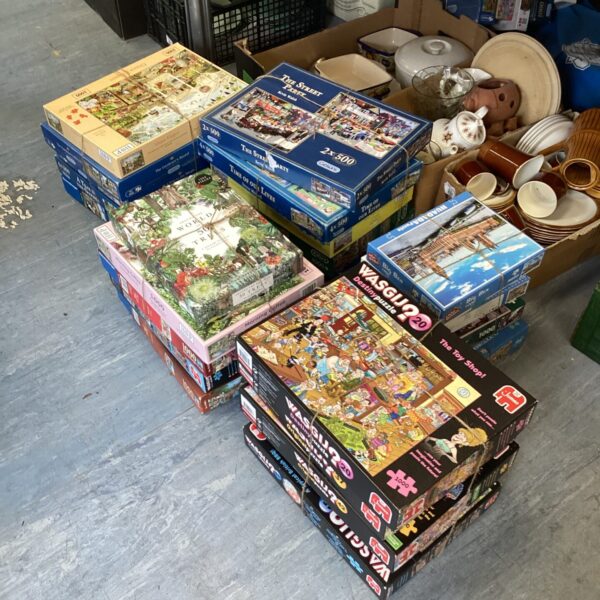 Assorted jigsaw puzzles including Wasgij sets in a mixed lot.