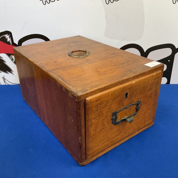 Front view of a vintage oak file box with a drawer.