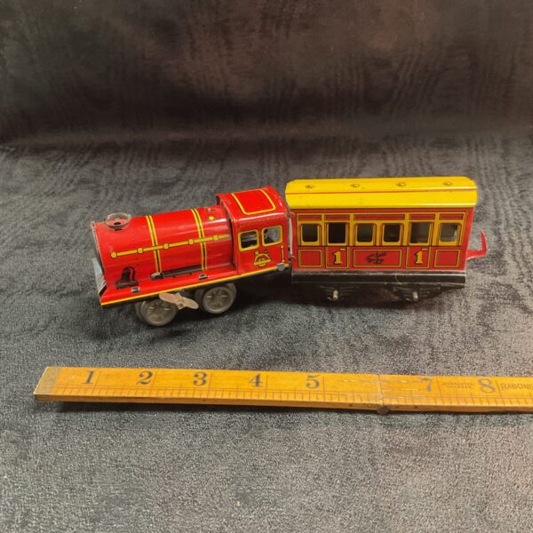 Vintage Brimtoy tinplate clockwork train with carriage.