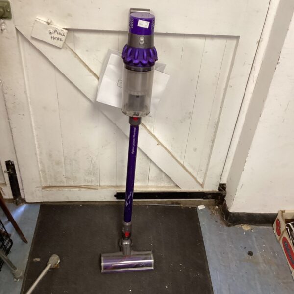 Used Dyson cordless vacuum cleaner in a home setting.
