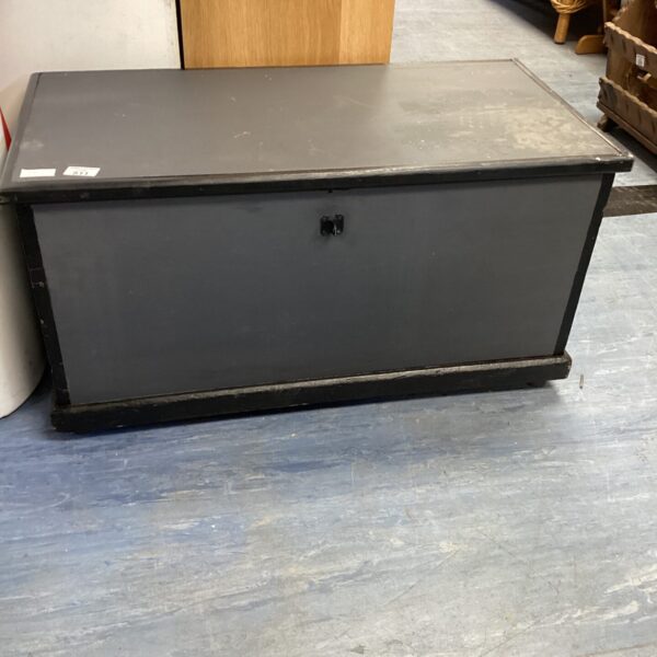Vintage grey and black wooden storage trunk for home use.