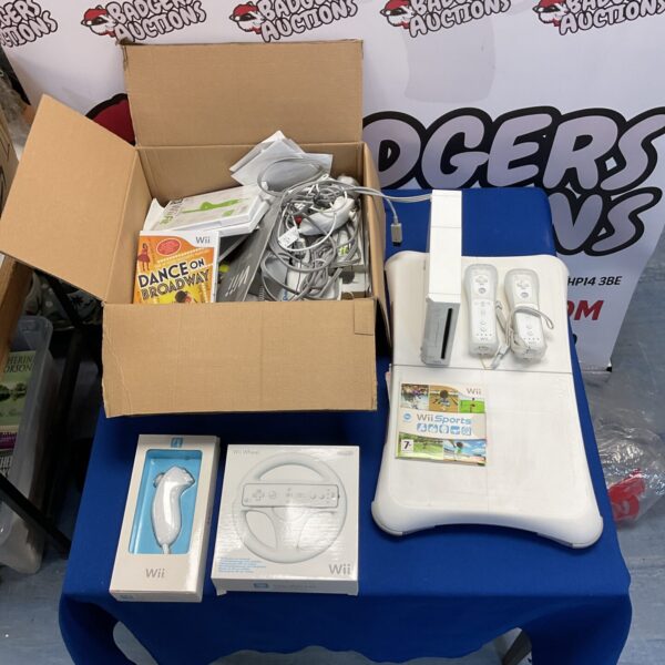 Nintendo Wii console with remotes, games, and Wii Fit board.