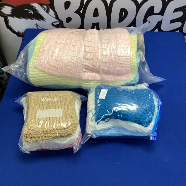 Colourful knitted wool blankets in two bags, handmade throws.