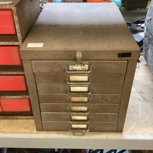 Vintage metal drawer unit with multiple drawers for workshop storage.