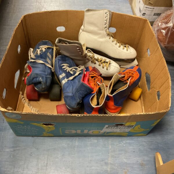 Vintage lot of ice and roller skates in various colours.