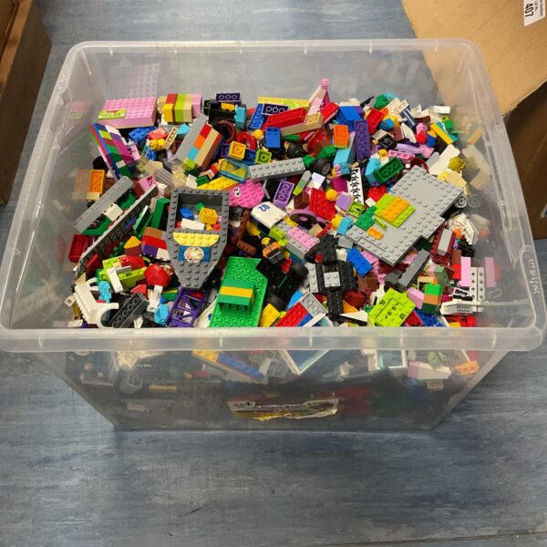 Large mixed Lego lot in a clear storage box with minifigures.