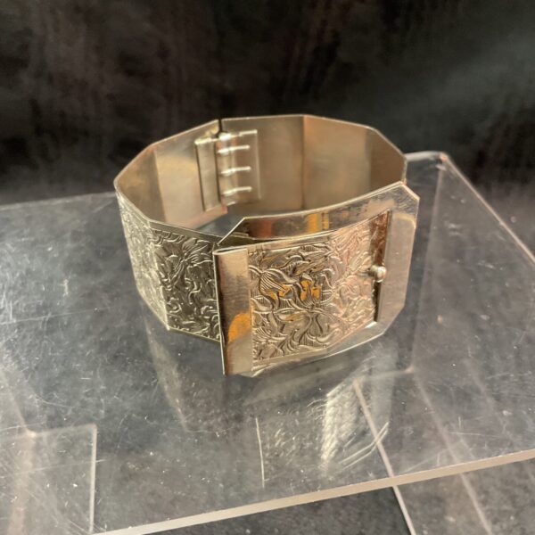 Close-up of vintage floral engraved belt buckle bracelet.
