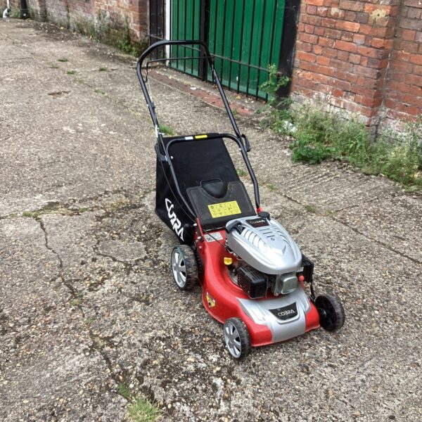 Cobra DG350v petrol lawn mower in a garden setting.