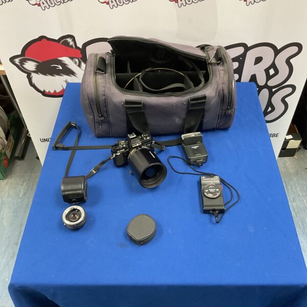 Vintage Minolta X-700 camera kit with lenses and flash.