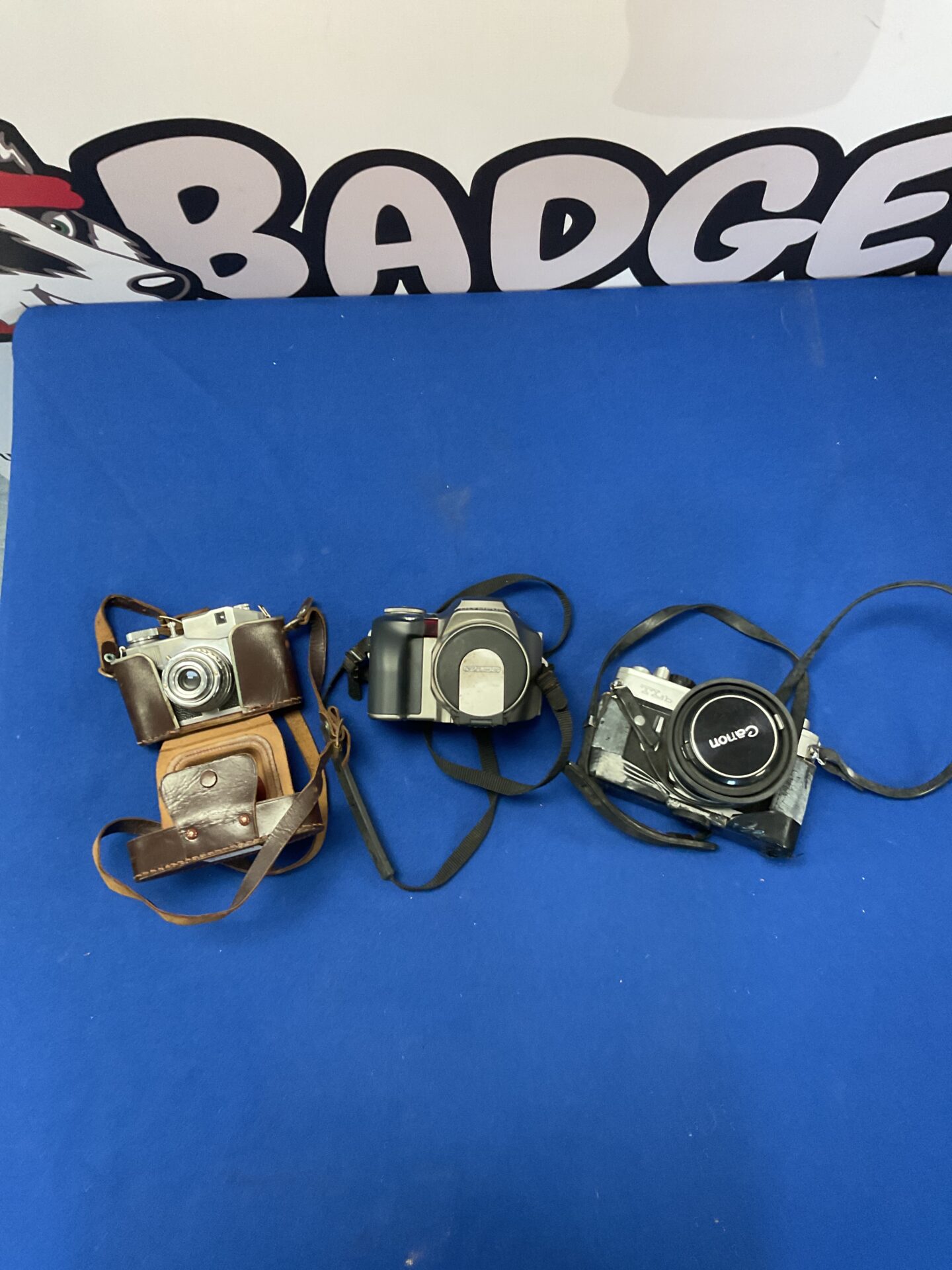 204 Canon TLb camera, Olympus camera, and Comet S camera