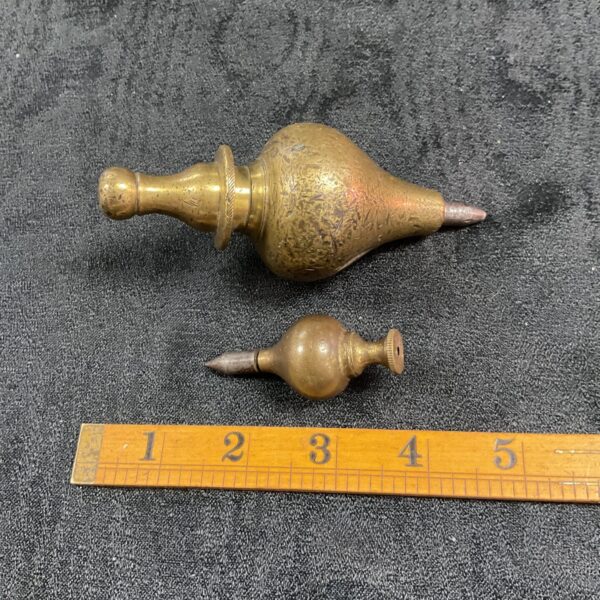 Faceted Victorian brass plumb bob, antique surveying tool.