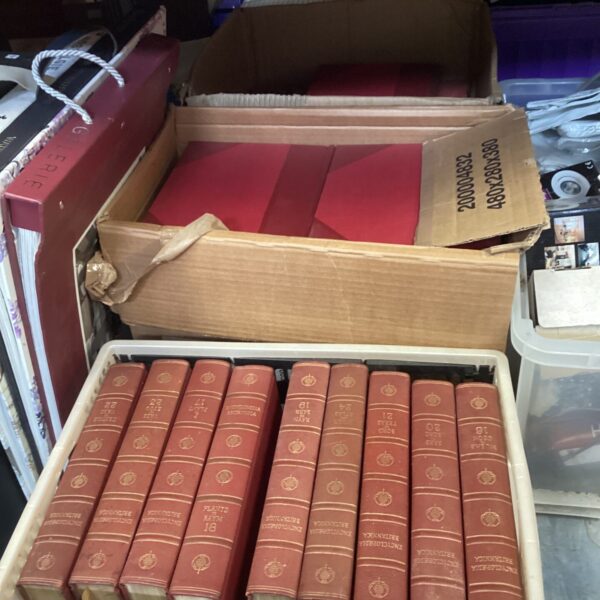 Stacked boxes of vintage Encyclopaedia Britannica sets.