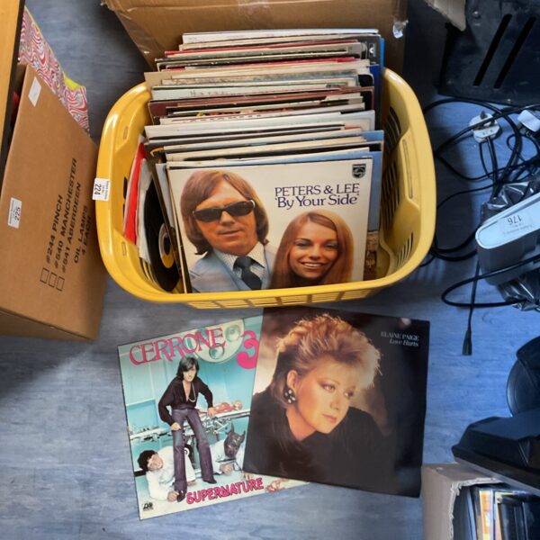 Basket of mixed 12” vinyl records for collectors.