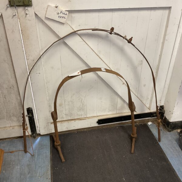 Antique chair clamps for woodworking, showing curved metal arms.