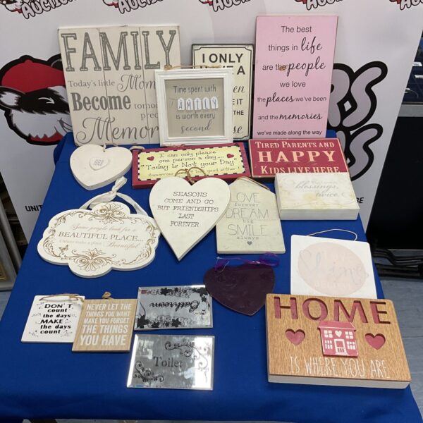 Collection of assorted vintage slogan signs for wall decor.