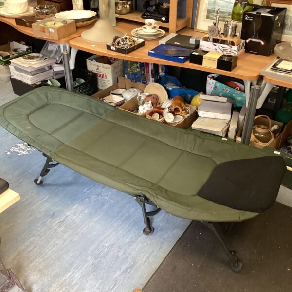 Green Carptrix folding fishing bed chair for outdoor angling.