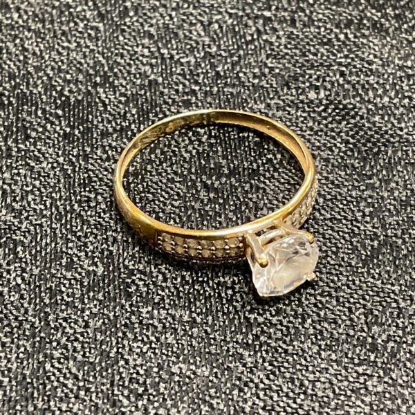 Close-up of a 9ct gold ring with a cubic zirconia stone.