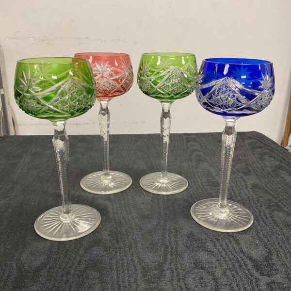 Set of four colourful cut crystal wine glasses.