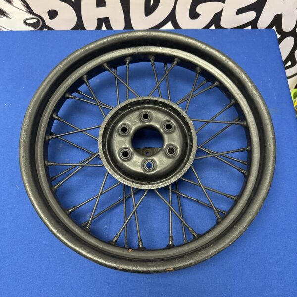 Vintage Morris 8 wire wheel converted into wall decor.