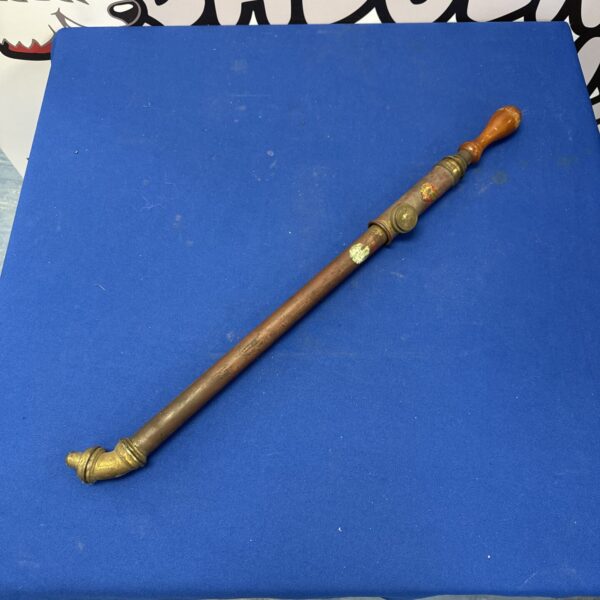Vintage brass garden sprayer with detailed nozzle and handle.