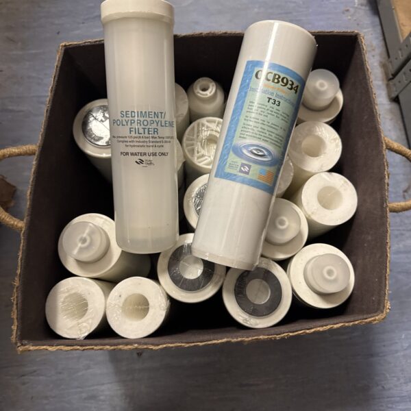 Stack of new ocb934 t33 water filter cartridges for filtration.