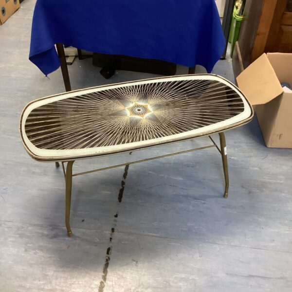 Vintage mid-century modern coffee table with starburst glass top.