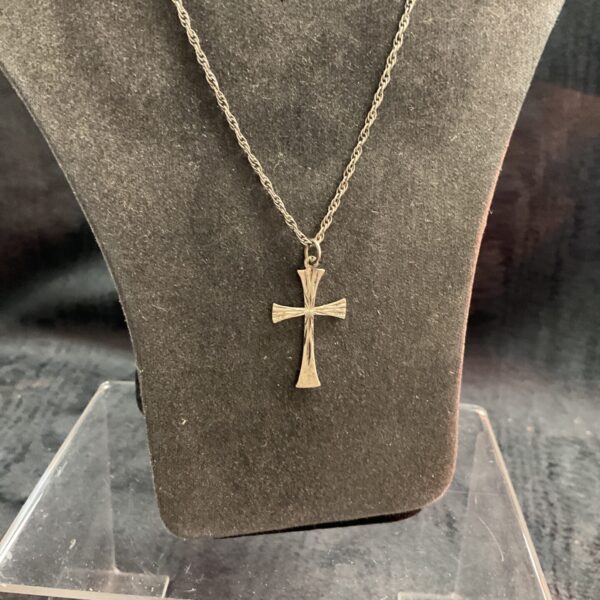 Vintage sterling silver cross necklace on a chain.