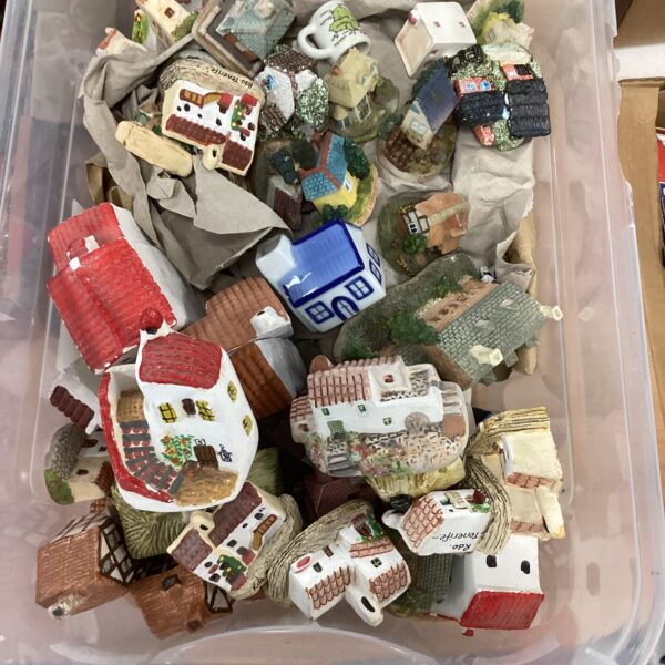 Large collection of colourful miniature pottery houses.