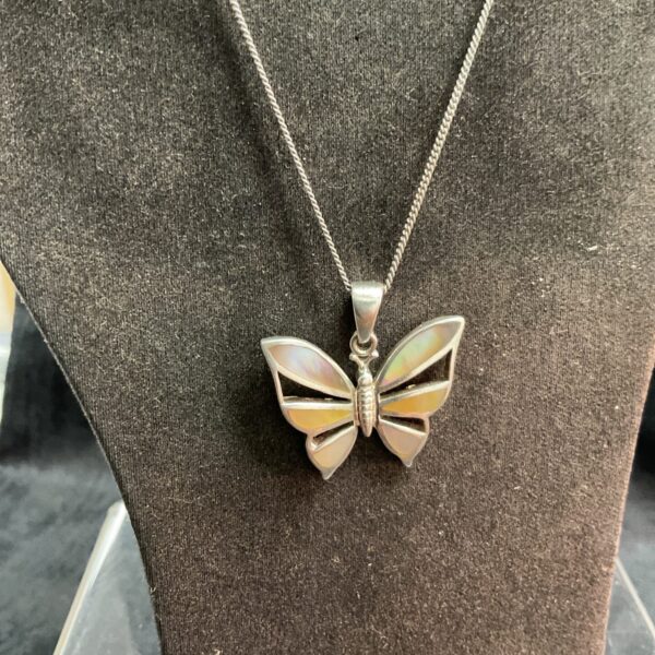Silver mother of pearl butterfly pendant on a chain.