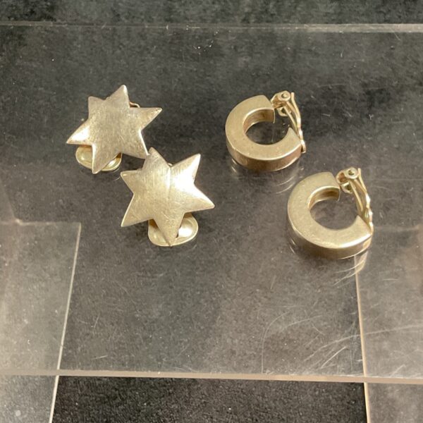 Pair of vintage 925 silver clipon earrings on a white surface.
