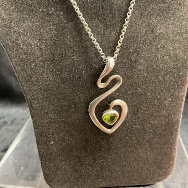 Silver peridot snake pendant on a silver chain.