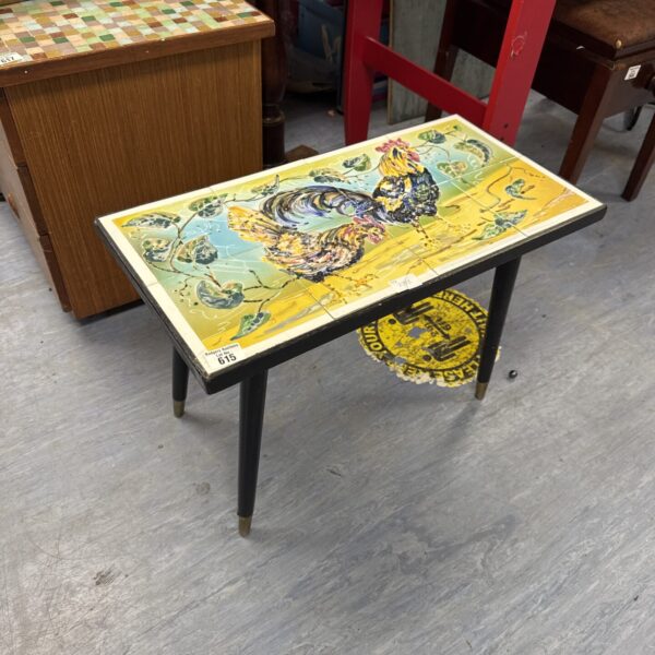 Vintage side table with colourful cockerel tile top.