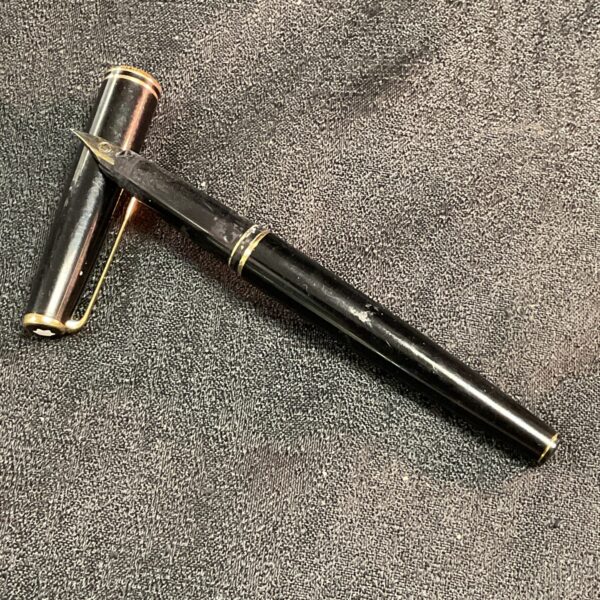 Vintage black fountain pen with gold trim.